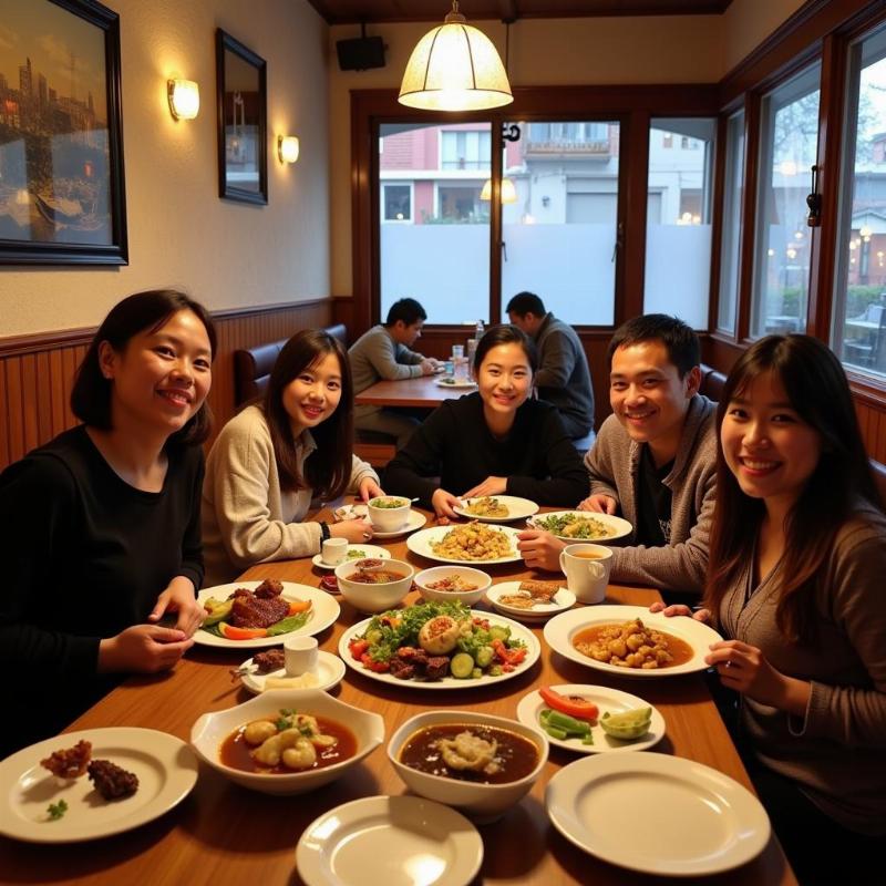 Family enjoying a traditional Sikkimese meal together in a local restaurant in Gangtok.