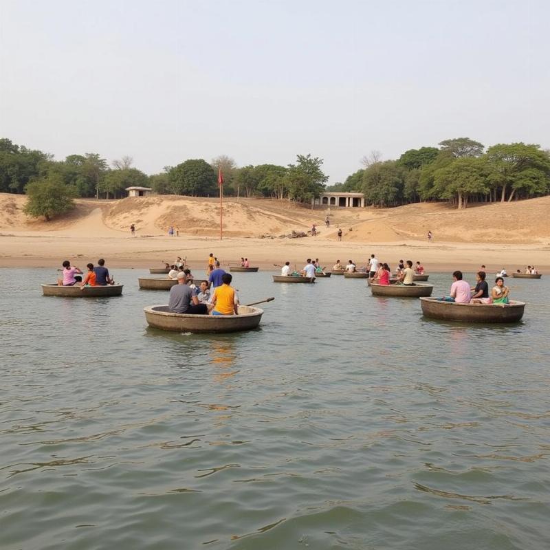 Tourists enjoying a coracle ride on the Cauvery River at Talakadu water place.