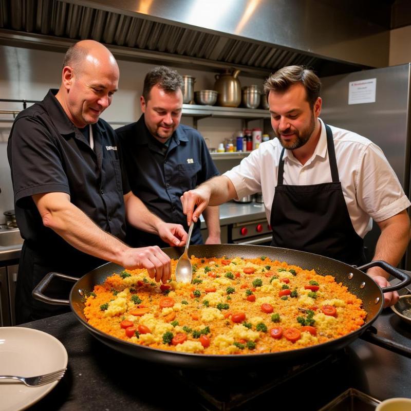 Gordon, Gino, and Fred cooking paella in Spain