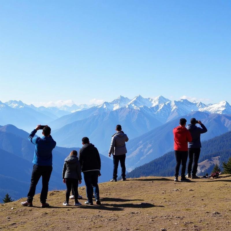 Visitors enjoying the view from Lal Tibba viewpoint in Landour.